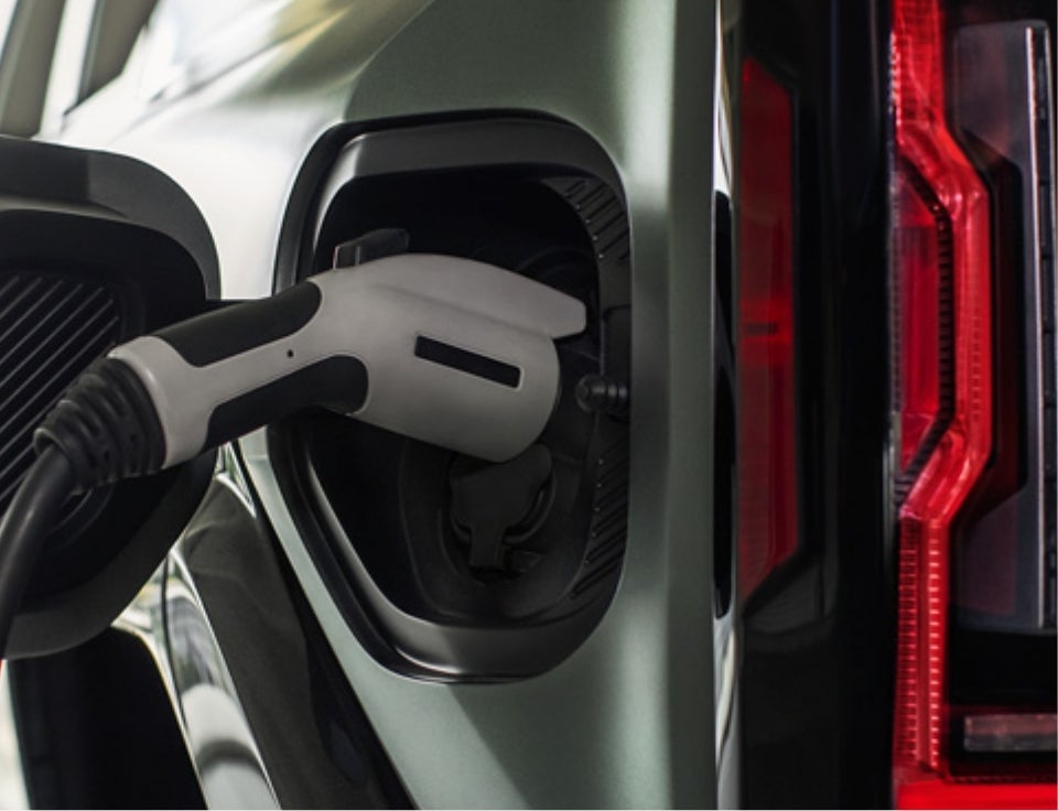 Close up of charging port with charger plugged in on a GMC Hummer EV SUV - Hove Buick GMC in Bradley IL